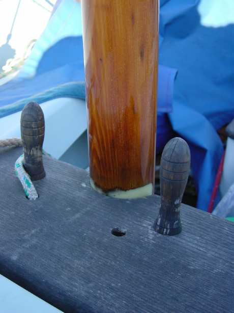 Photograph of the two belaying pins which pass through holes in the wooden mast thwart