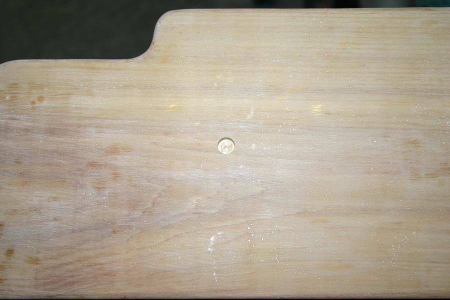 Top of pilot hole in plank drilled to 10 mm for plug