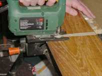 Photograph showing the capping being cut to the correct length using a jig saw