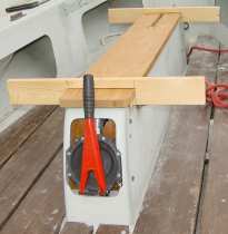 Photo, using two wooden jigs to hold the capping in position