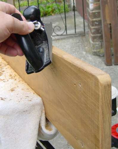 Photo, using a plane to bevel the edges of the capping