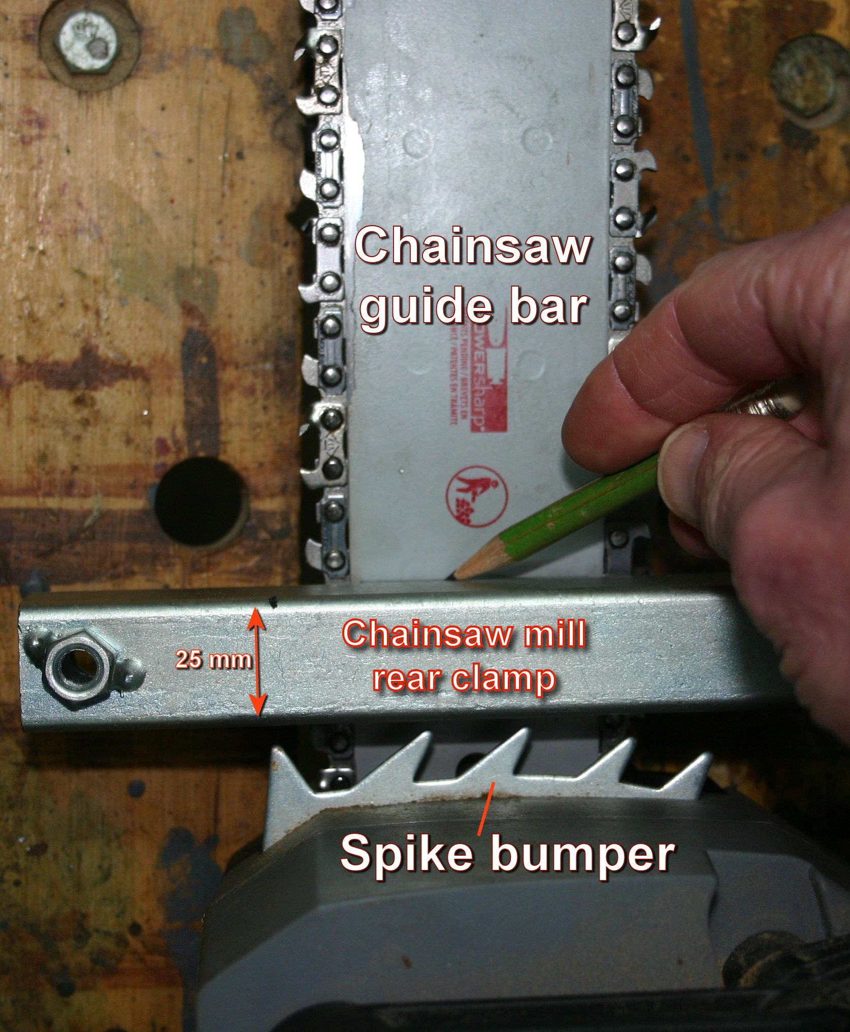 Marking the position of a rear bolting hole in the chainsaw guide bar - 1.