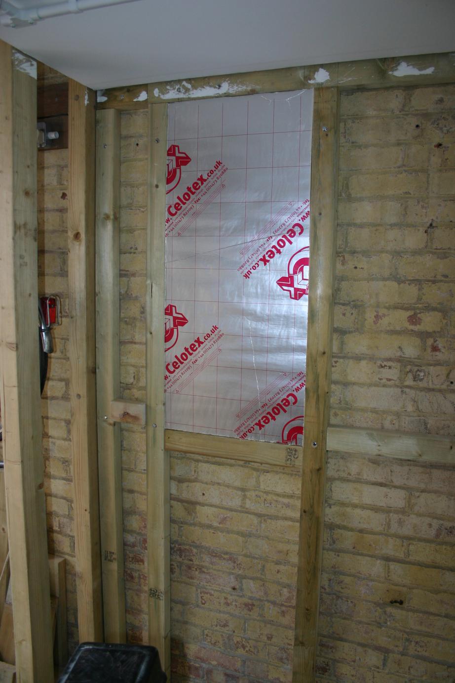 The first insulation board pressed into place, 30th August 2015.
