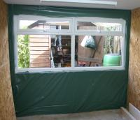 A polythene vapour barrier stapled to the studwork surrounding the window.
