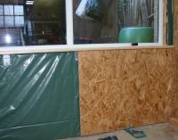 Work in progress sheathing beneath the window with OSB.