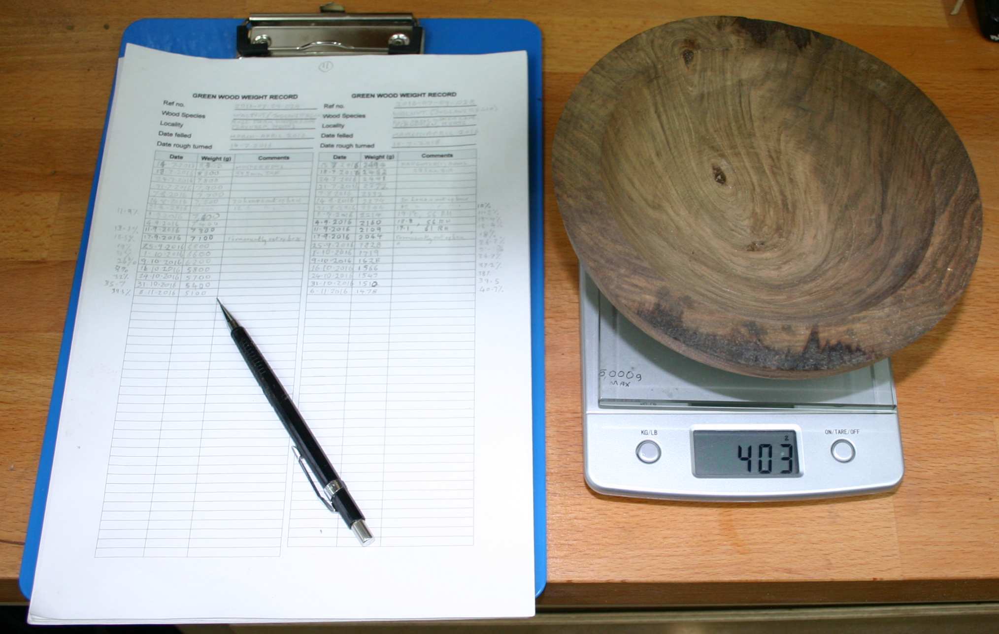 Recording the weight of a rough-turned bowl.