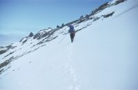 Eric Lawther ascending the ridge between Pettigrew Scarp and McPherson crags to establish a survey flag station at spot height 330 metres. Annenkov Island, December 1972.
