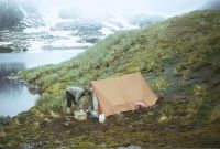 Camping in the small mountain tent at the campsite located at the north-western end of Intrusion Lake. This was a useful base when surveying the north-western end of Annenkov Island. The food box at the entrance to the tent was carried across from the main camp site depot. January 1973.