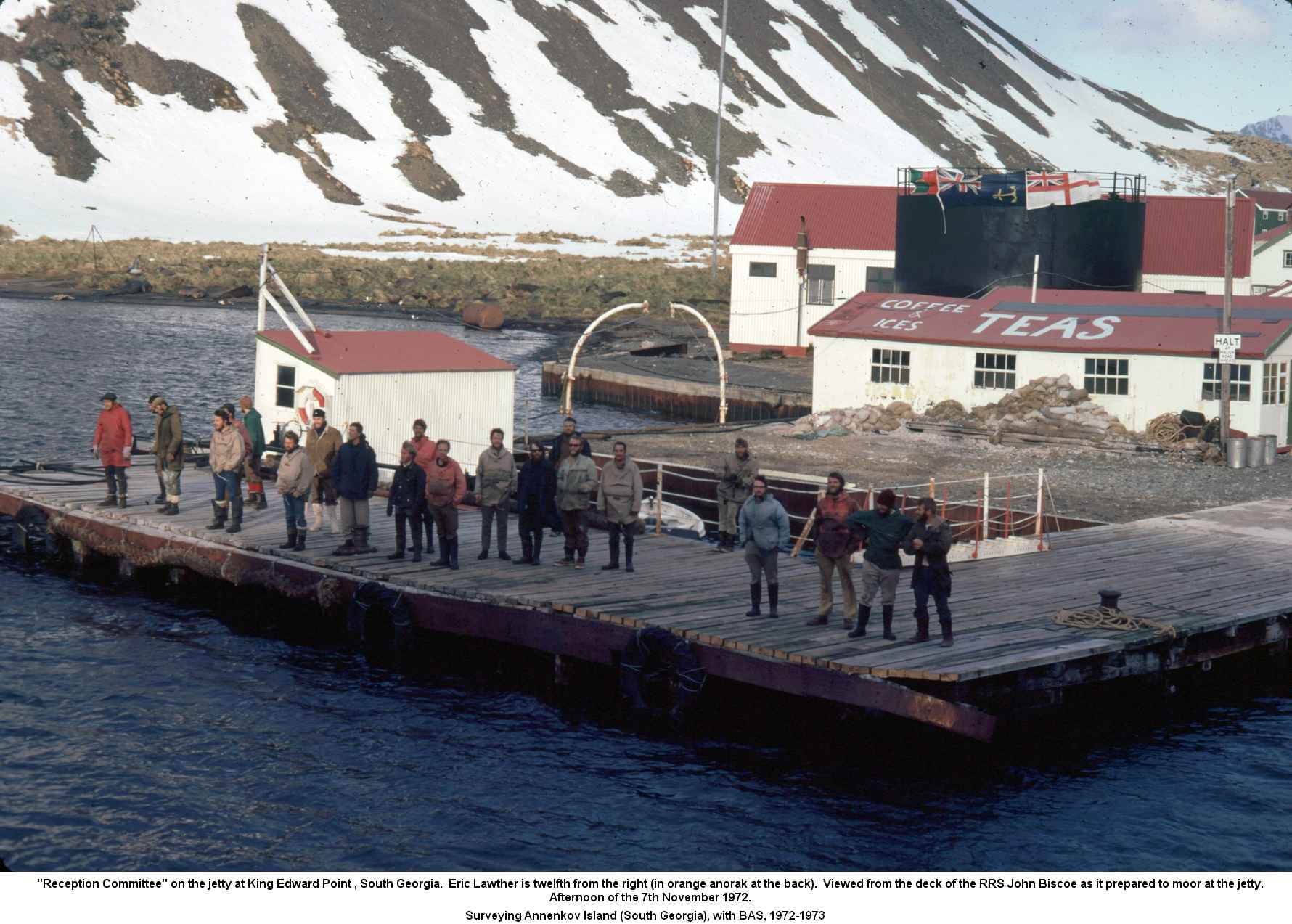 "Reception Committee" on the jetty at King Edward Point , South Georgia.  Eric Lawther is twelfth from the right (in orange anorak at the back).  Viewed from the deck of the RRS John Biscoe as it prepared to moor at the jetty.
Afternoon of the 7th November 1972.