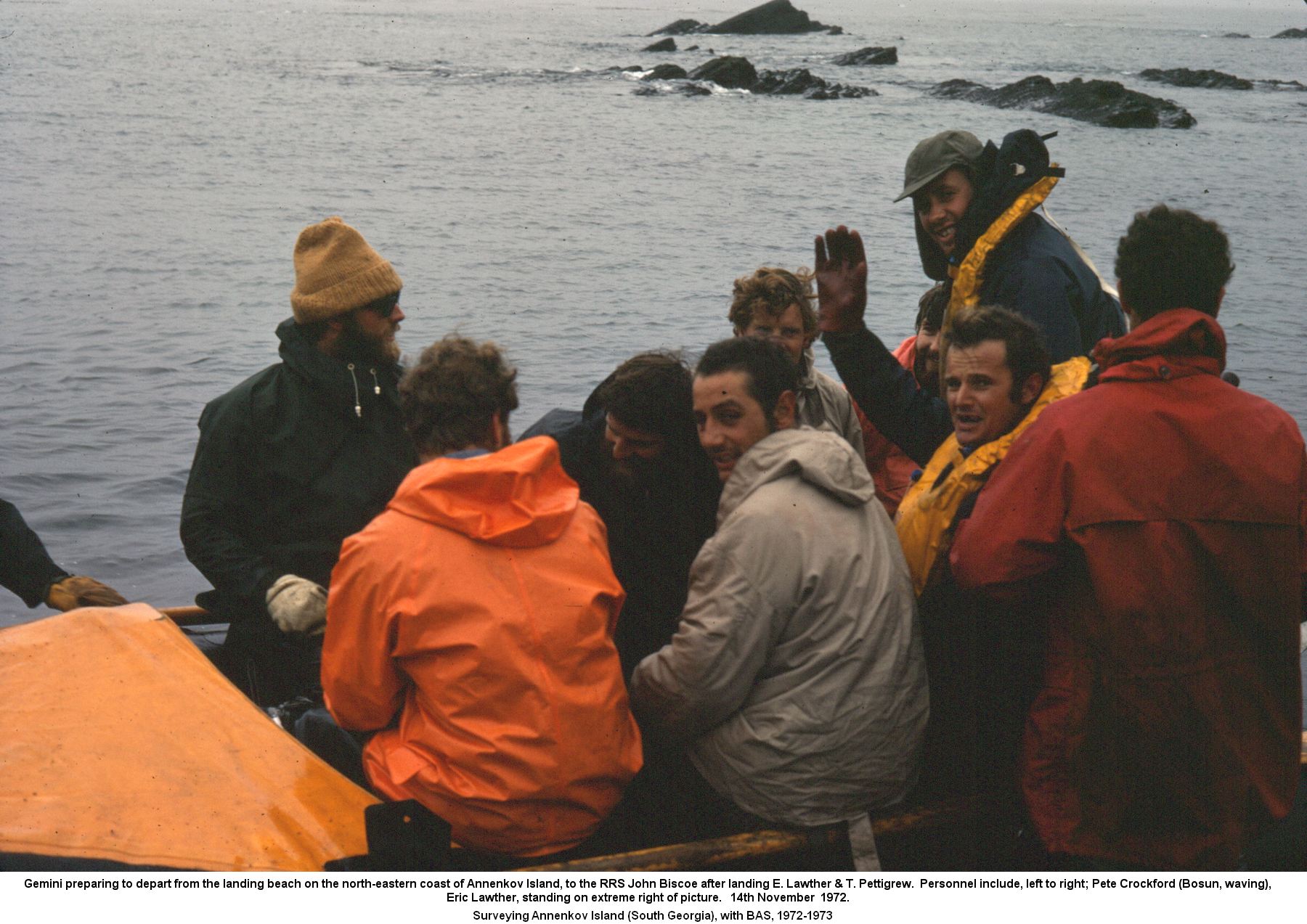 Gemini preparing to depart from the landing beach on the north-eastern coast of Annenkov Island, to the RRS John Biscoe after landing E. Lawther & T. Pettigrew.  Personnel include, left to right; Pete Crockford (Bosun, waving),
Eric Lawther, standing on extreme right of picture. 14th November  1972.
