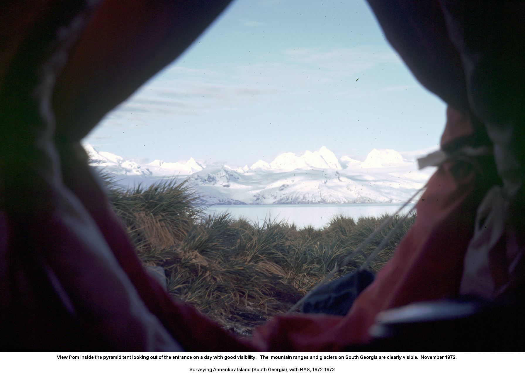View from inside the pyramid tent looking out of the entrance on a day with good visibility.   The  mountain ranges and glaciers on South Georgia are clearly visible.  November 1972.