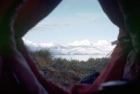 View from inside the pyramid tent looking out of the entrance on a day with good visibility. The mountain ranges and glaciers on South Georgia are clearly visible. November 1972.