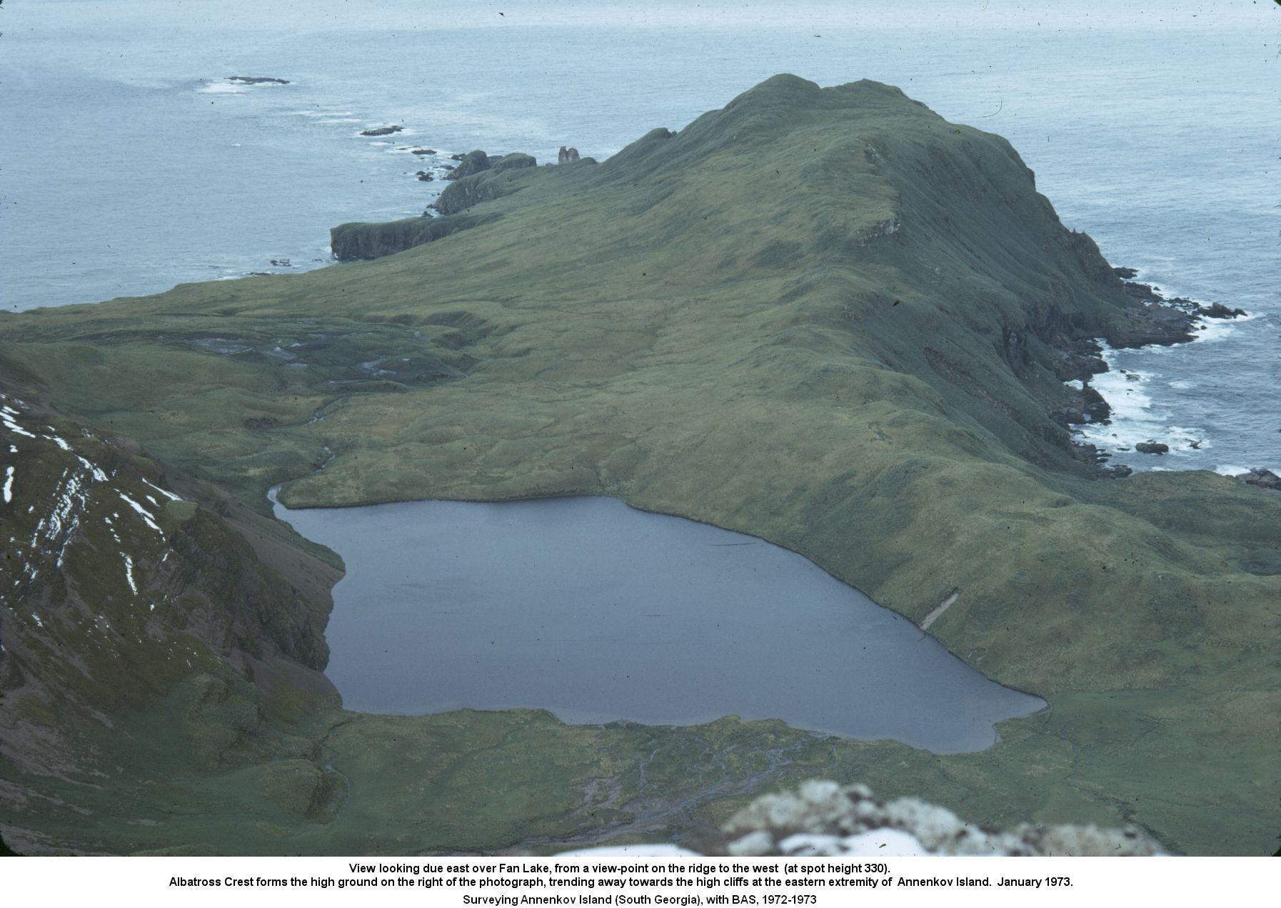 View looking due east over Fan Lake, from a view-point on the ridge to the west  (at spot height 330). 
Albatross Crest forms the high ground on the right of the photograph, trending away towards the high cliffs at the eastern extremity of  Annenkov Island.  January 1973.