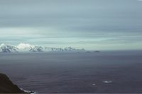 View looking south-east from Albatross Crest on Annenkov Island showing the Pickersgill Islands with the extreme south-eastern end of South Georgia in the background. January 1973.